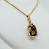 Yellow gold double chain with diamond and precious gemstone center from GoldQuestJewelers jewelry store in Boston MA