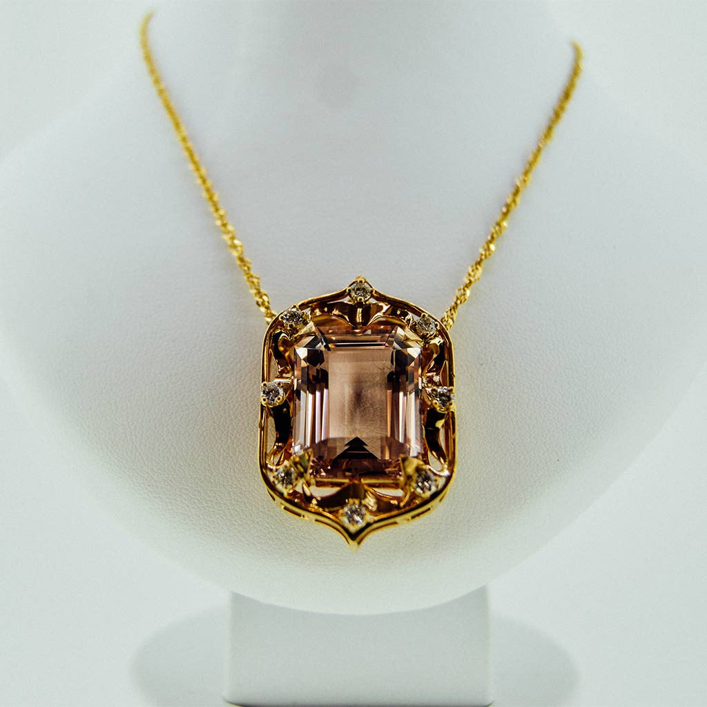 Yellow gold necklace with a precious stone center from GoldQuestJewelers near Boston MA