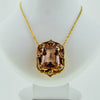 Yellow gold necklace with a precious stone center from GoldQuestJewelers near Boston MA